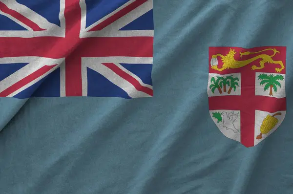 stock image Fiji flag depicted on folded wavy fabric of old cloth close up