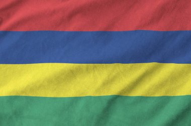 Mauritius flag depicted on folded wavy fabric of old cloth close up clipart