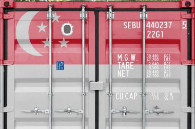 Singapore flag depicted on metal doors of shipping cargo container outdoors in docks area close up clipart