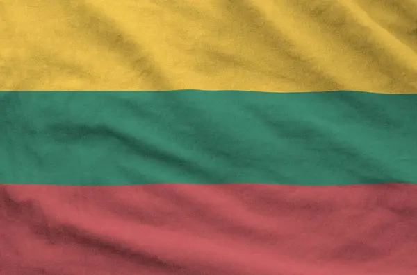 stock image Lithuania flag depicted on folded wavy fabric of old cloth close up