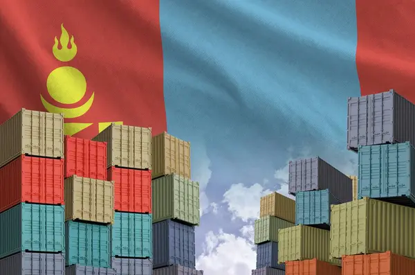 stock image Mongolia flag and big stack of shipping cargo containers in docks with sky background close up