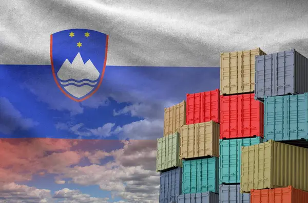 stock image Slovenia flag and big stack of shipping cargo containers in docks with sky background close up