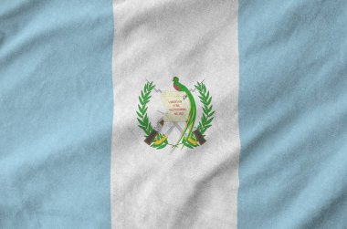 Guatemala flag depicted on folded wavy fabric of old cloth close up clipart