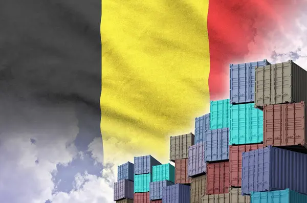 Stock image Belgium flag and big stack of shipping cargo containers in docks with sky background close up