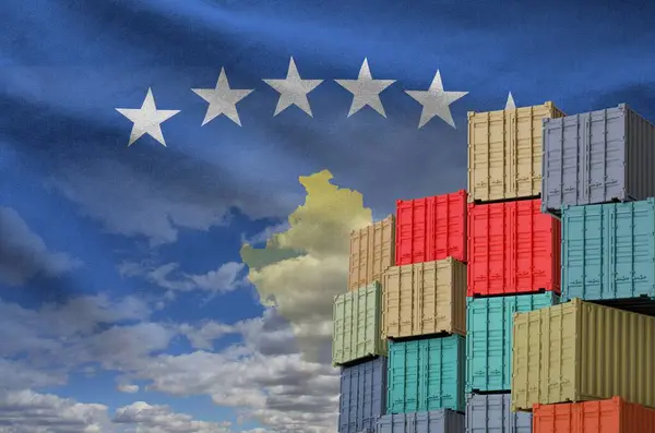 stock image Kosovo flag and big stack of shipping cargo containers in docks with sky background close up