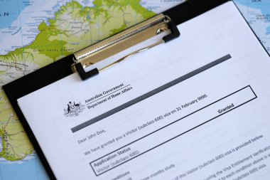 KYIV, UKRAINE - JULY 10, 2024 Application status for Australian visitor visa on table of Australian Government Department of Home Affairs close up clipart