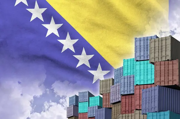 stock image Bosnia and Herzegovina flag and big stack of shipping cargo containers in docks with sky background close up