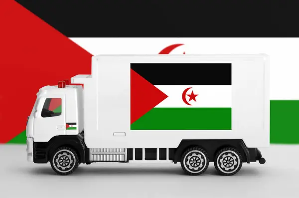 stock image Western Sahara flag depicted on side wall of white delivery van close up. Shipping and local delivery concept