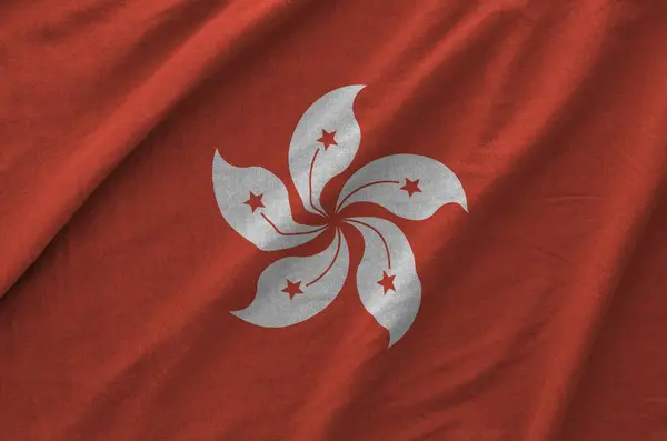 stock image Hong kong flag depicted on folded wavy fabric of old cloth close up