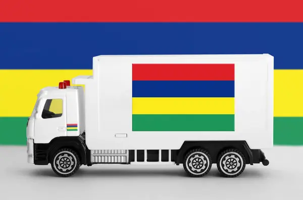 stock image Mauritius flag depicted on side wall of white delivery van close up. Shipping and local delivery concept