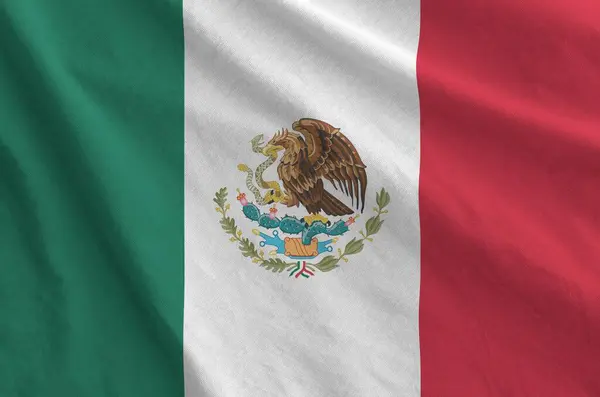 stock image Mexico flag depicted on folded wavy fabric of old cloth close up