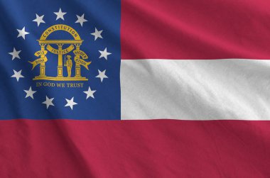 Georgia US state flag depicted on folded wavy fabric of old cloth close up clipart