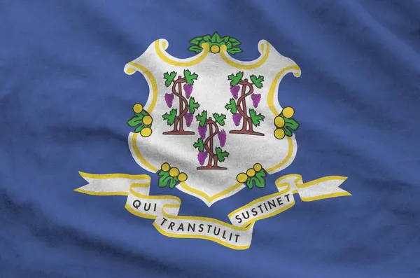 stock image Connecticut US state flag depicted on folded wavy fabric of old cloth close up