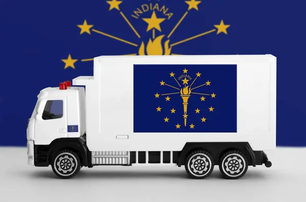 Stock image Indiana US state flag depicted on side wall of white delivery van close up. Shipping and local delivery concept