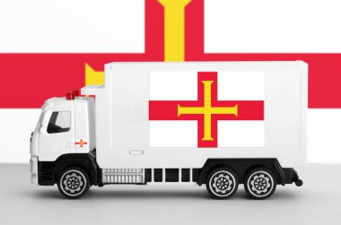 Guernsey bayrağı beyaz minibüsün yan duvarında tasvir edilmiş. Nakliye ve yerel teslimat kavramı