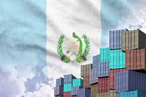 stock image Guatemala flag and big stack of shipping cargo containers in docks with sky background close up