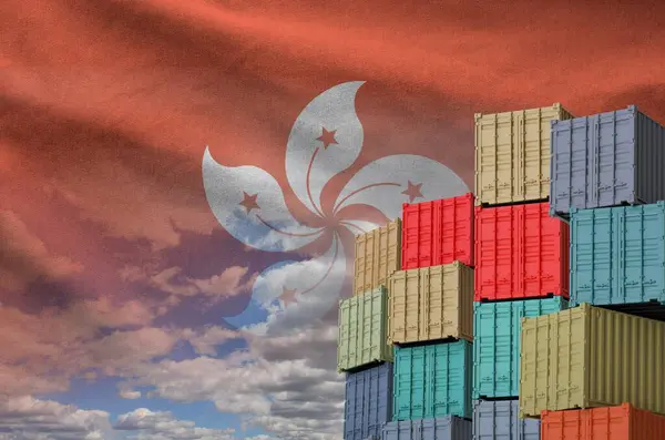 stock image Hong kong flag and big stack of shipping cargo containers in docks with sky background close up