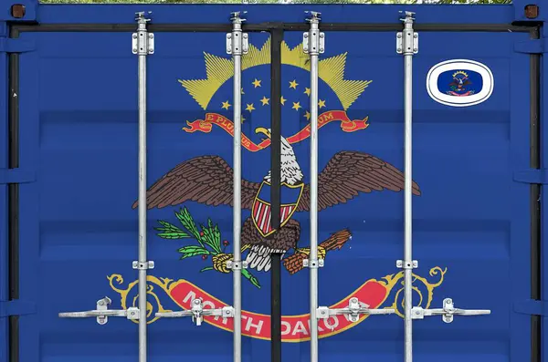 stock image North Dakota US state flag depicted on metal doors of shipping cargo container outdoors in docks area close up