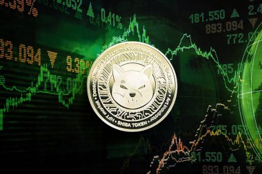 KYIV, UKRAINE - AUGUST 17, 2024 Shiba coin on dark cryptocurrency digital trading chart in green colors close up clipart