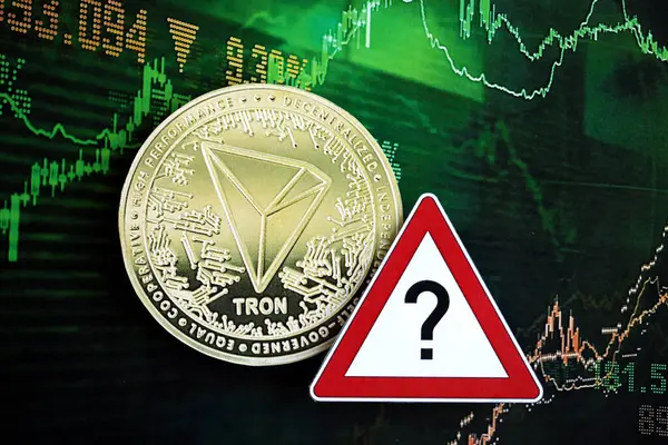 stock image KYIV, UKRAINE - AUGUST 17, 2024 TRON Coin and red paper question sign on chart background close up