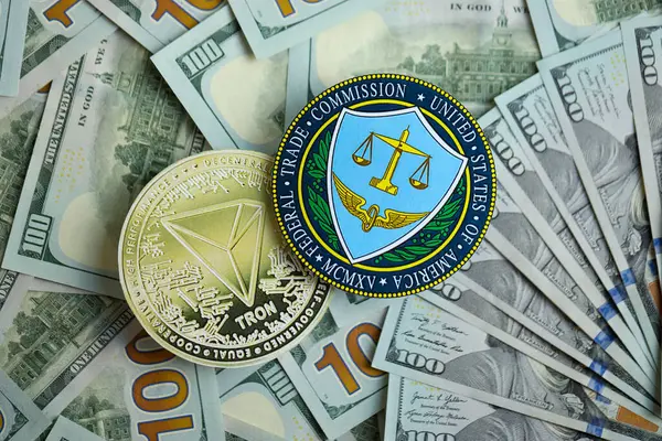 stock image KYIV, UKRAINE - AUGUST 17, 2024 TRON Coin and US Federal Trade Commission sign on many USD dollar money bills close up