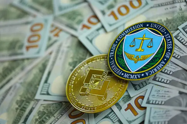 stock image KYIV, UKRAINE - AUGUST 17, 2024 Binance BNB coin and US Federal Trade Commission sign on many USD dollar money bills close up