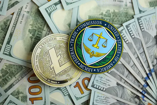 stock image KYIV, UKRAINE - AUGUST 17, 2024 Litecoin LTC coin and US Federal Trade Commission sign on many USD dollar money bills close up