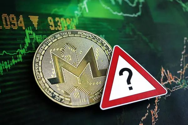 stock image KYIV, UKRAINE - AUGUST 17, 2024 Monero XMR coin and red paper question sign on chart background close up