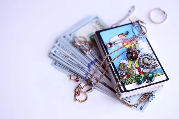 stock image KYIV, UKRAINE - JULY 10, 2024 Tarot minor and major arcana cards of Rider Waite esoteric deck and golden rings and necklace chains. Many tarot cards for fortune telling and expensive items close up