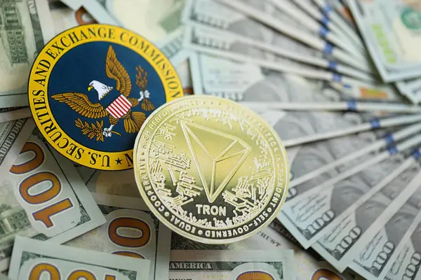 stock image KYIV, UKRAINE - AUGUST 17, 2024 TRON Coin and US Securities and Exchange Commission sign on money background close up