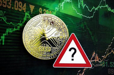 KYIV, UKRAINE - AUGUST 17, 2024 Ripple XRP Coin and red paper question sign on chart background close up clipart