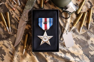 KYIV, UKRAINE - JULY 10, 2024 US Silver Star medal. United States military award medal with ribbon and pin. Handmade paper theater props close up clipart