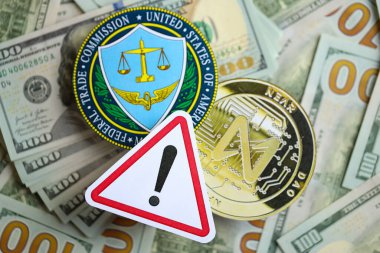 KYIV, UKRAINE - AUGUST 17, 2024 NEAR coin and US Federal Trade Commission sign on many USD dollar money bills close up clipart