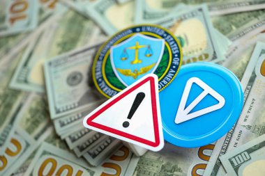 KYIV, UKRAINE - AUGUST 17, 2024 Telegram TON coin and US Federal Trade Commission sign on many USD dollar money bills close up clipart