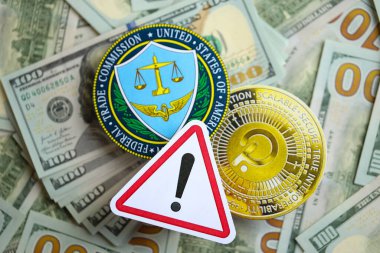 KYIV, UKRAINE - AUGUST 17, 2024 PolkaDot coin and US Federal Trade Commission sign on many USD dollar money bills close up clipart