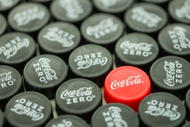 KYIV, UKRAINE - 29 Ocak 2025 Coca Cola Plastik şişe kapağı arka plan. Kapak malzemesi geri dönüştürülebilir. Plastik şişelerin kapaklarını geri dönüşümden önce çıkar.