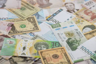 Farklı para birimlerinden ve ülkelerden yüklü miktarda para. Uluslararası nakitin çeşitli arka planında büyük bir yığın var.