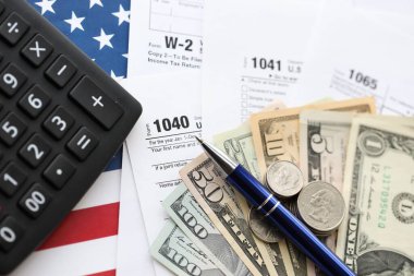 Amerikan Doları. Para banknotları ve vergi formundaki kalem ve hesap makineli paralar boş. Muhasebe ve vergi ödeme dönemi kavramı