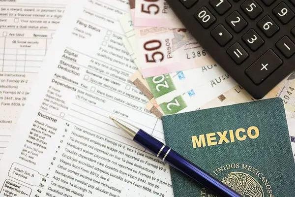 Meksika pezosu para faturaları kalem, hesap makinesi, pasaport ve vergi formlarıyla dolu. Finans ve bankacılık kavramı
