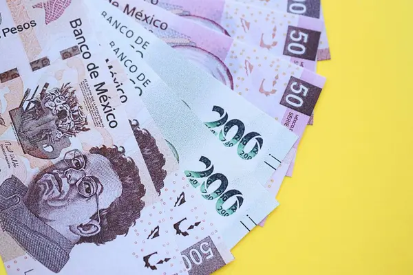 Meksika pezosu faturaları büyük miktarlarda sarı renkli masaya yakın duruyor. Finans ve bankacılık kavramı