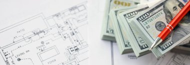 Kalemle birlikte yüklü miktarda Amerikan doları banknotları ve konut projesinin planları yakın plan. Yatırım ve inşaat projesi kavramı