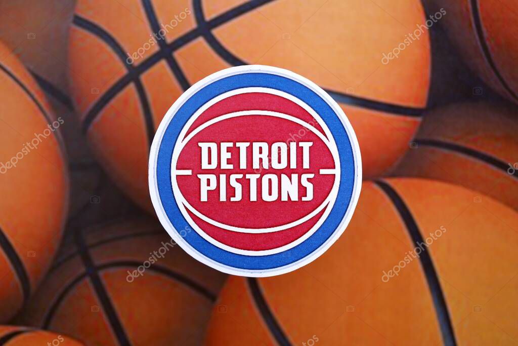 KYIV, UKRAINE - FEBRUARY 23, 2025 Detroit Pistons basketball team badge lies on basketball balls background banner