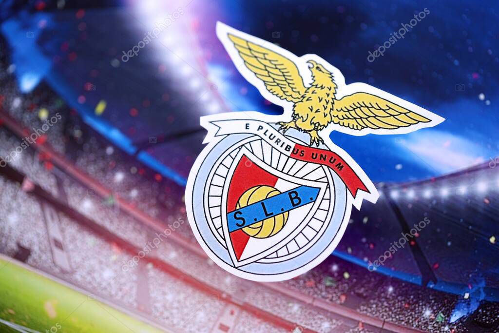 KYIV, UKRAINE - FEBRUARY 23, 2025 Sport Lisboa e Benfica football club badge lies on soccer stadium background banner