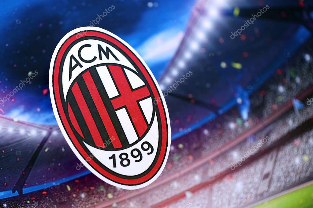 KYIV, UKRAINE - FEBRUARY 23, 2025 AC Milan football club badge lies on soccer stadium background banner