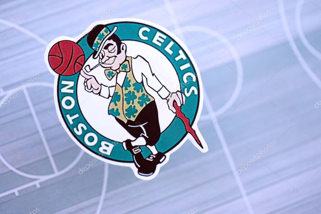 KYIV, UKRAINE - FEBRUARY 23, 2025 Boston Celtics basketball team badge lies on basketball stadium map background banner