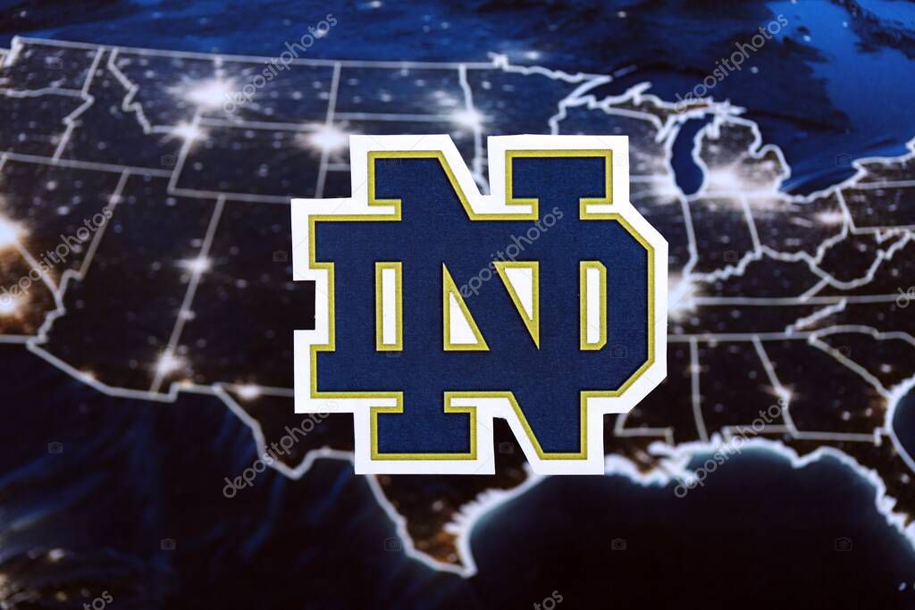 KYIV, UKRAINE - FEBRUARY 23, 2025 Notre Dame Fighting Irish basketball team badge lies on United States map background banner
