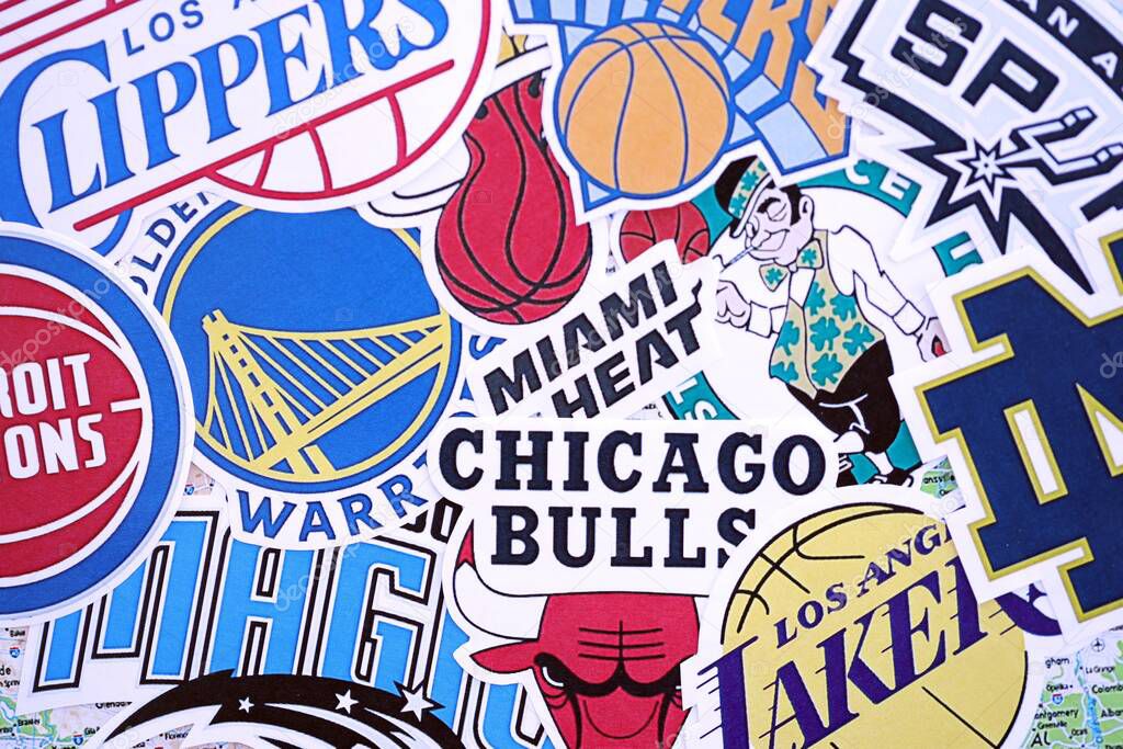 KYIV, UKRAINE - FEBRUARY 23, 2025 Many paper emblems of NBA basketball teams lies in big pile close up