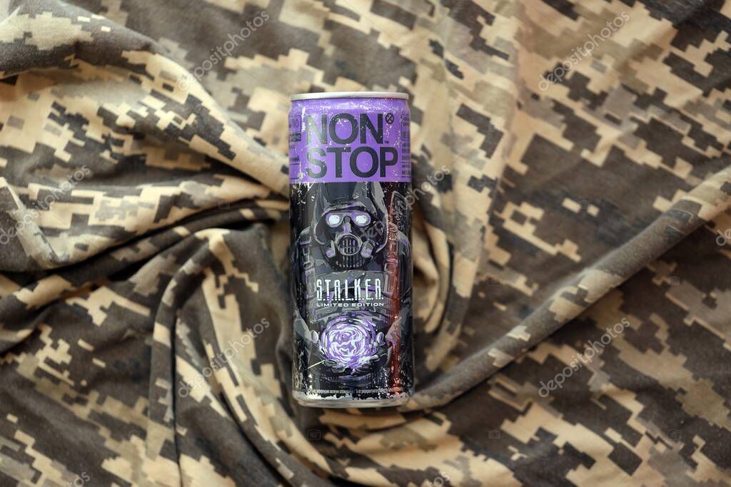 KYIV, UKRAINE - APRIL 19, 2025 Non Stop energy drink with limited edition design of Stalker and character with gas mask on purple can close up