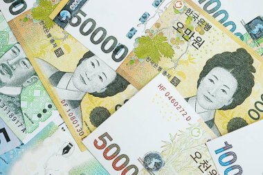 Güney Kore büyük miktarlarda para kazandı. Beyaz renkli masada yatıyor. Yakın plan. Finans ve bankacılık kavramı