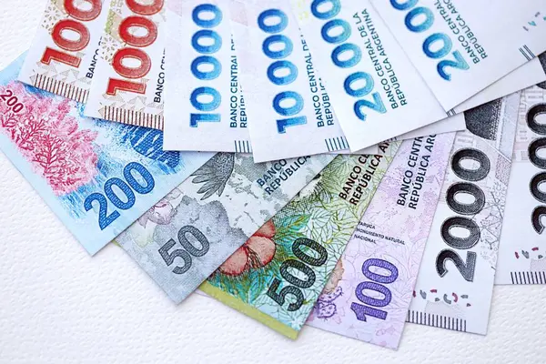 Arjantin pezosu büyük miktarlarda para beyaz masada yakın planda yatıyor. Finans ve bankacılık kavramı